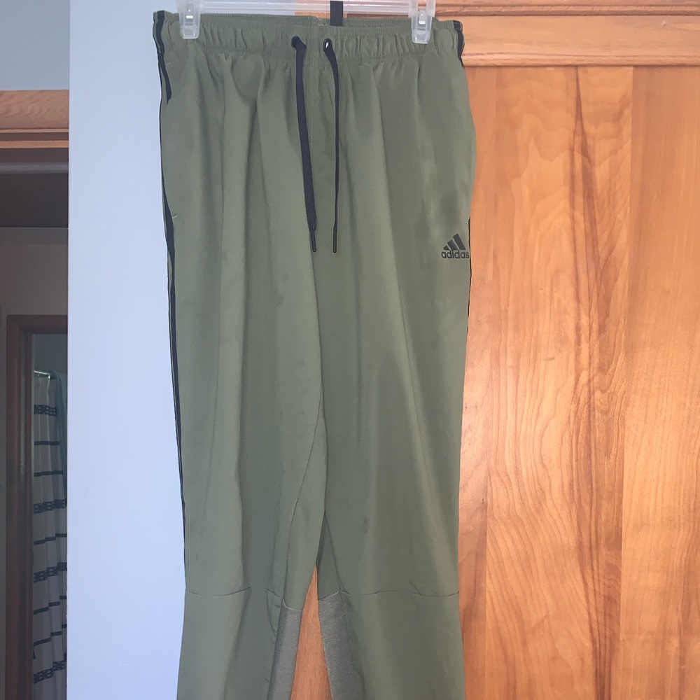 Army green Adidas sweatpants